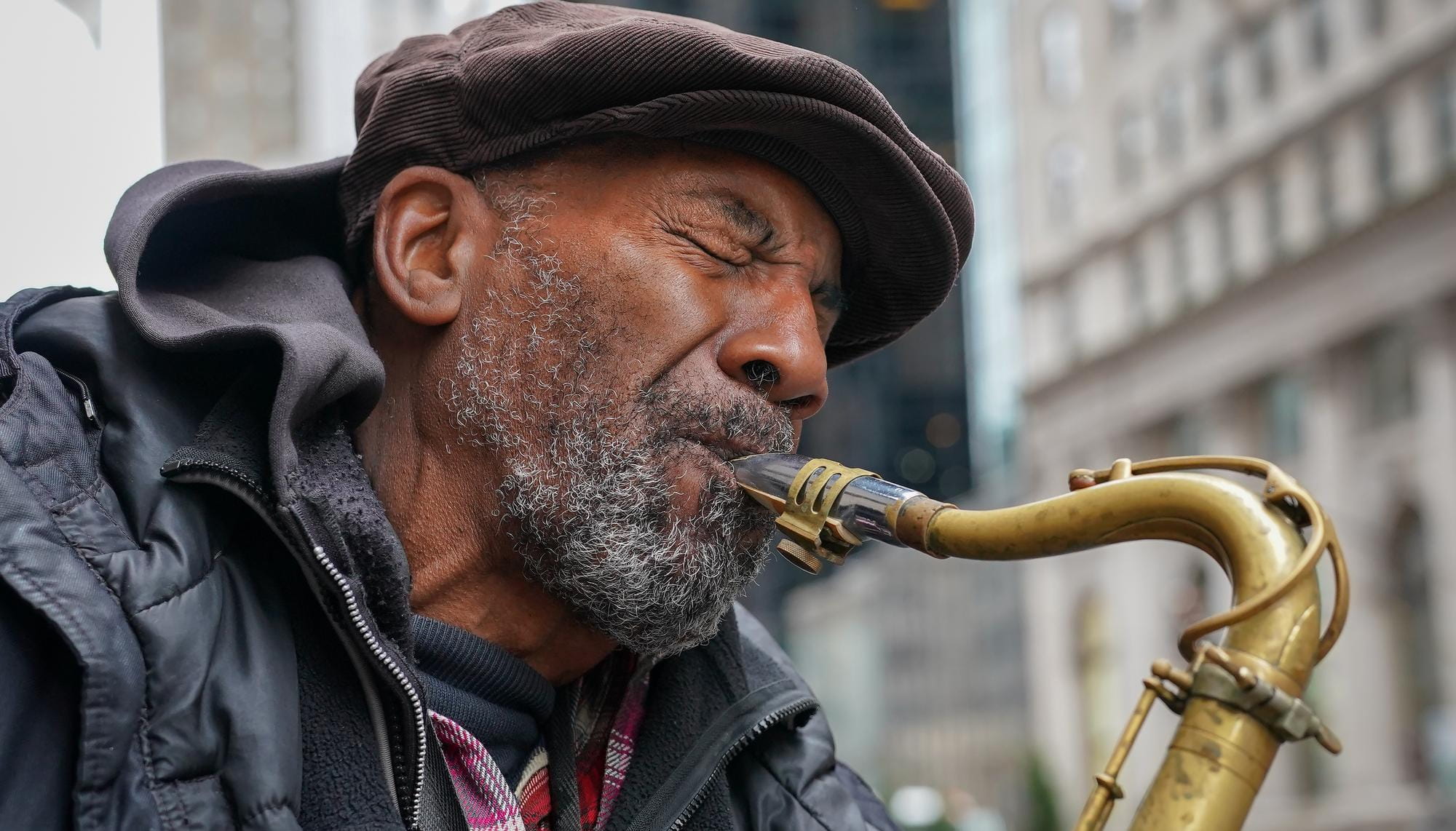 Closeup of man playing the saxaphone.